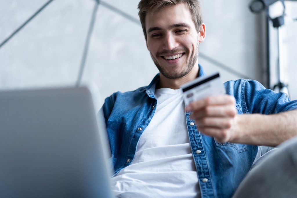 Guy excited to make a credit card purchase