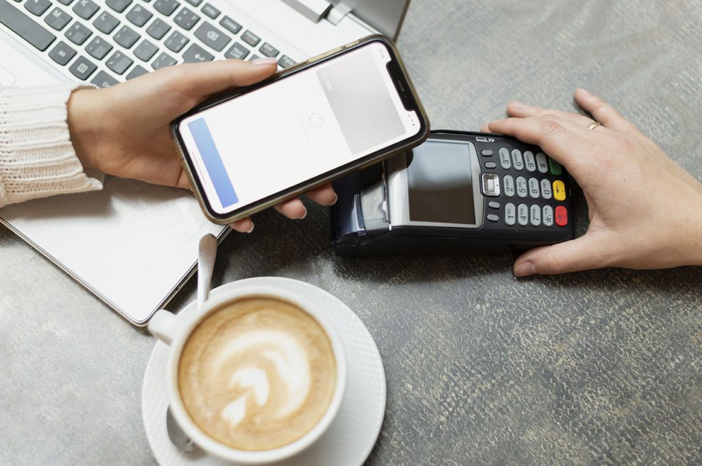 person paying with smartphone