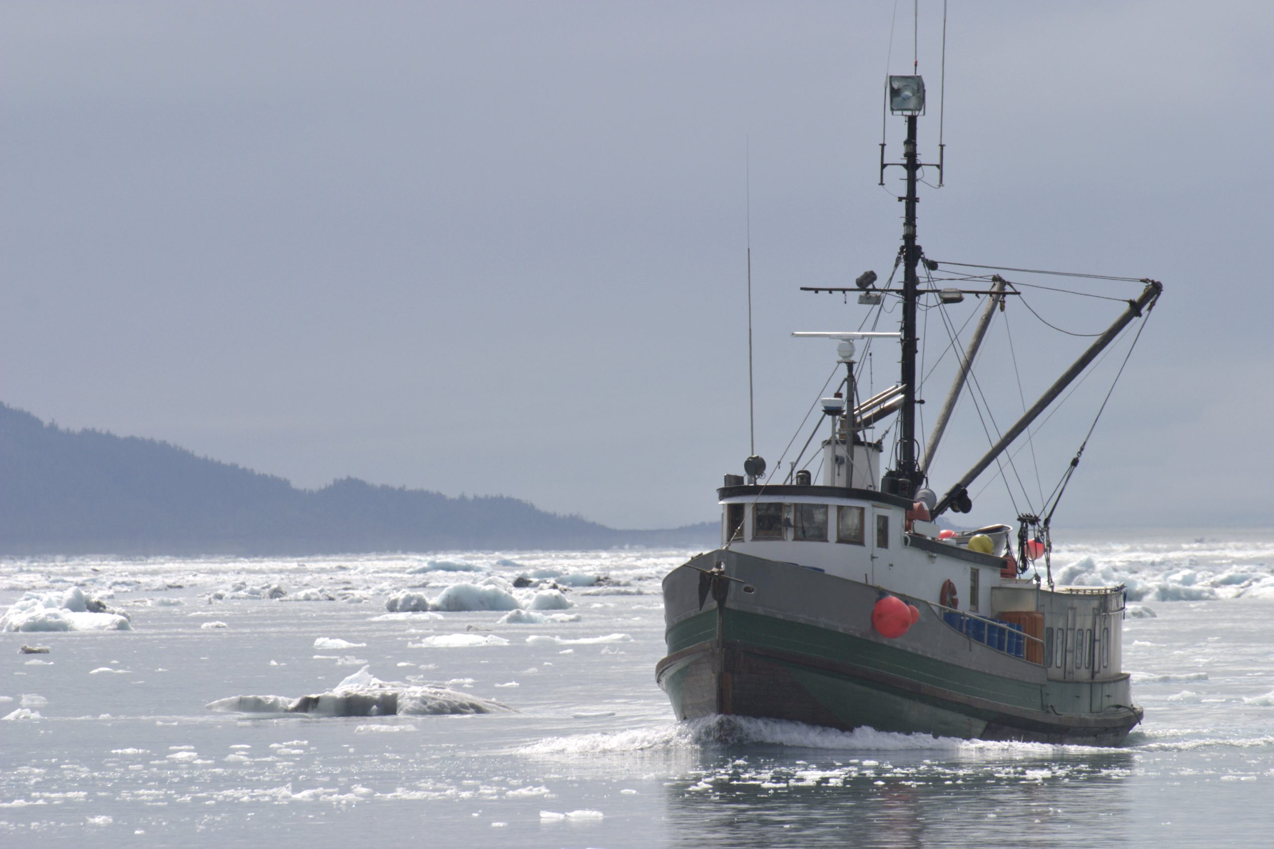 Fishing Trawler in Ice Filled Alaskan Water - stock photo Fishing boat cruising in icy water.